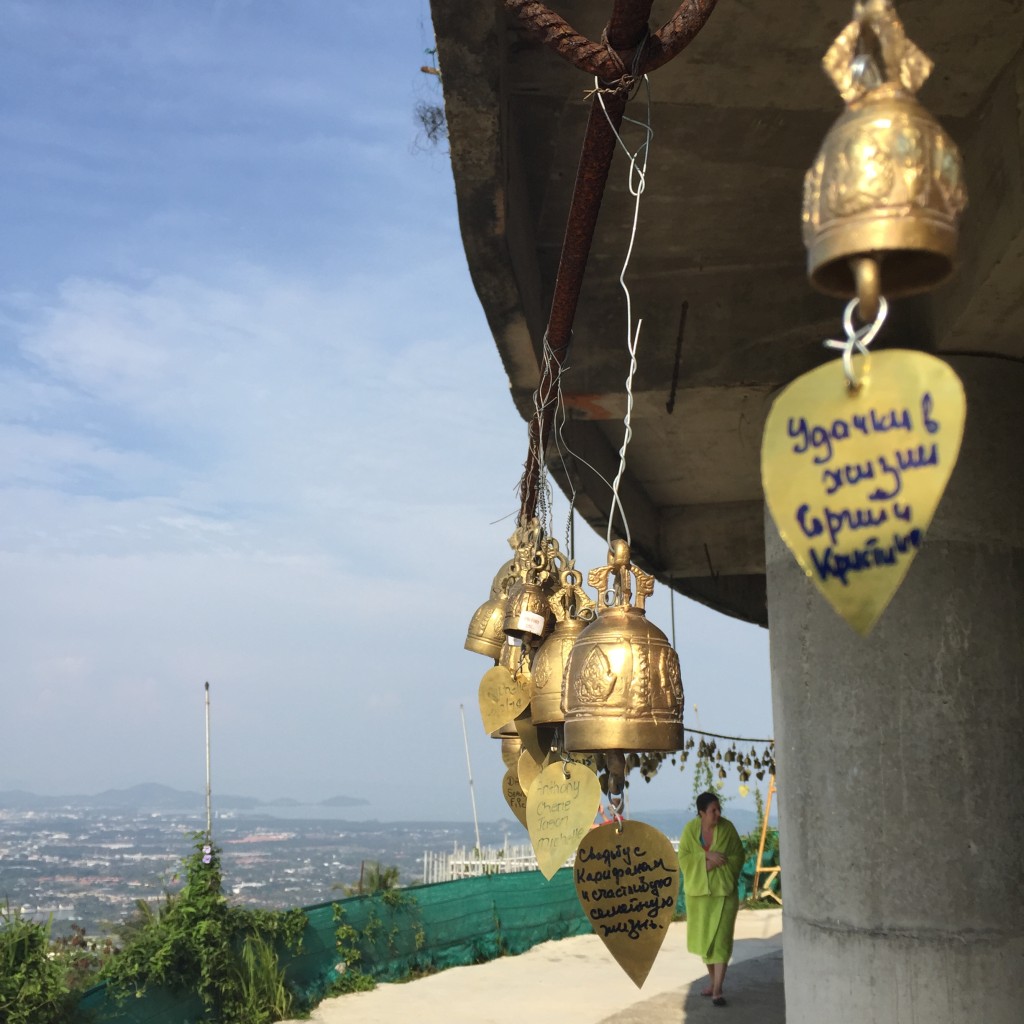 Bells with wishes written on them, hung around the Buddha