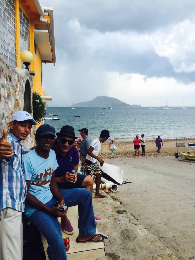 Locals celebrating Saint Carmens Day on the beach, rain or shine!