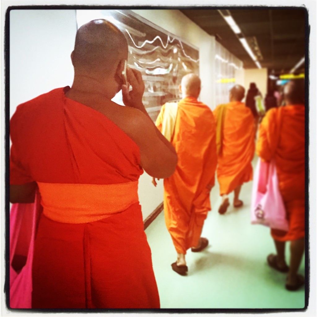 Monk meets new age technology. Photo from Bangkok Airport.